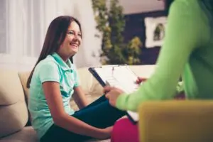 Girl smiling during a counseling session.